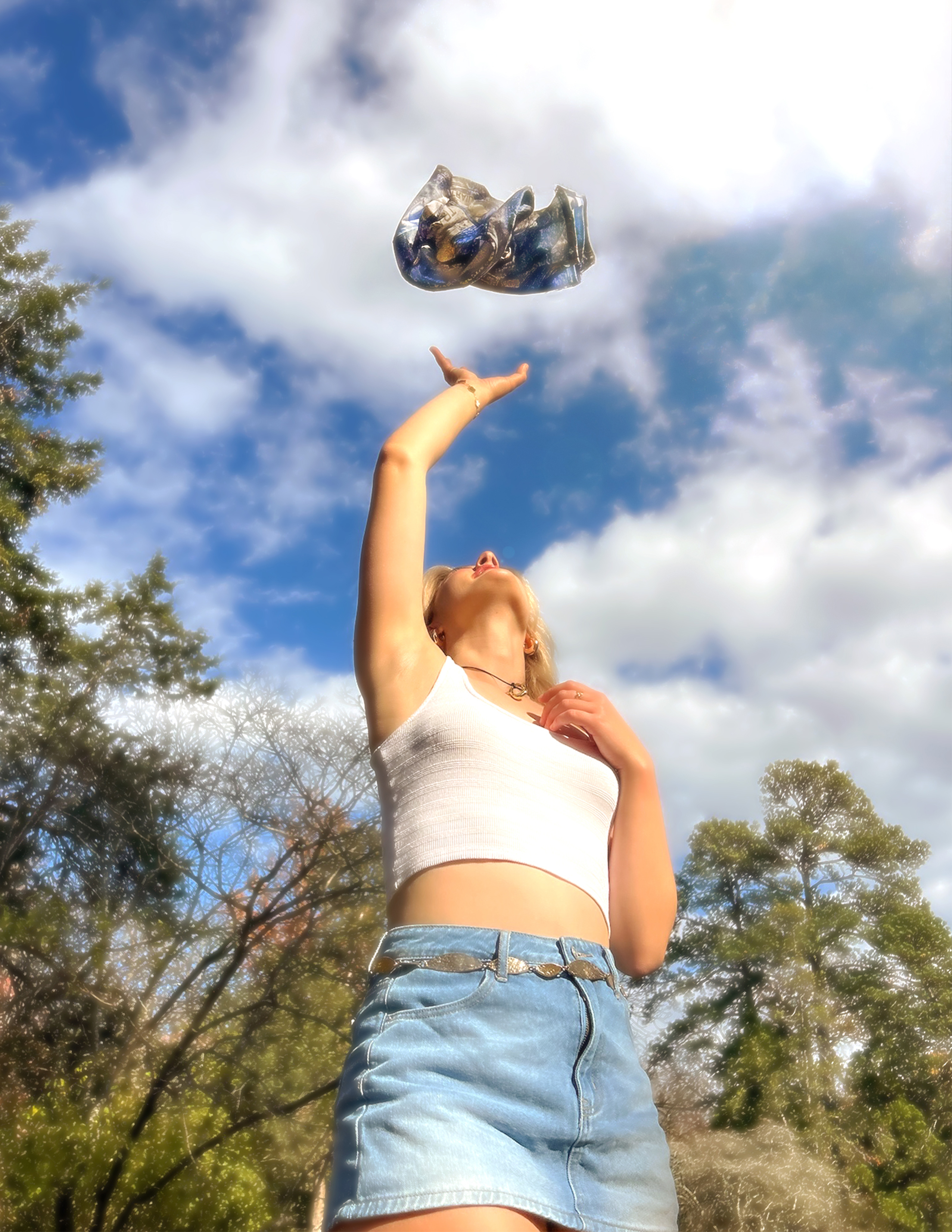 Shot 1 — low angle, model reaching up for the Levi's shirt falling from the sky